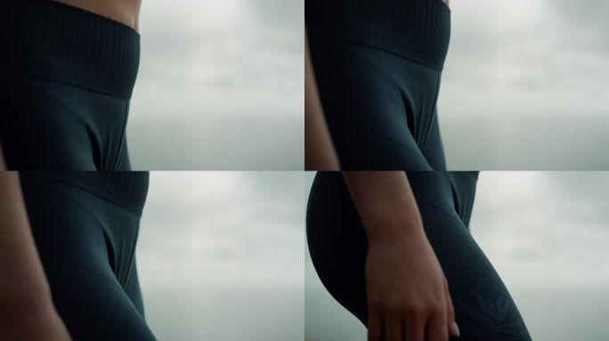 沙滩上穿着紧身打底裤的女性身材特写。女运动员站在海边