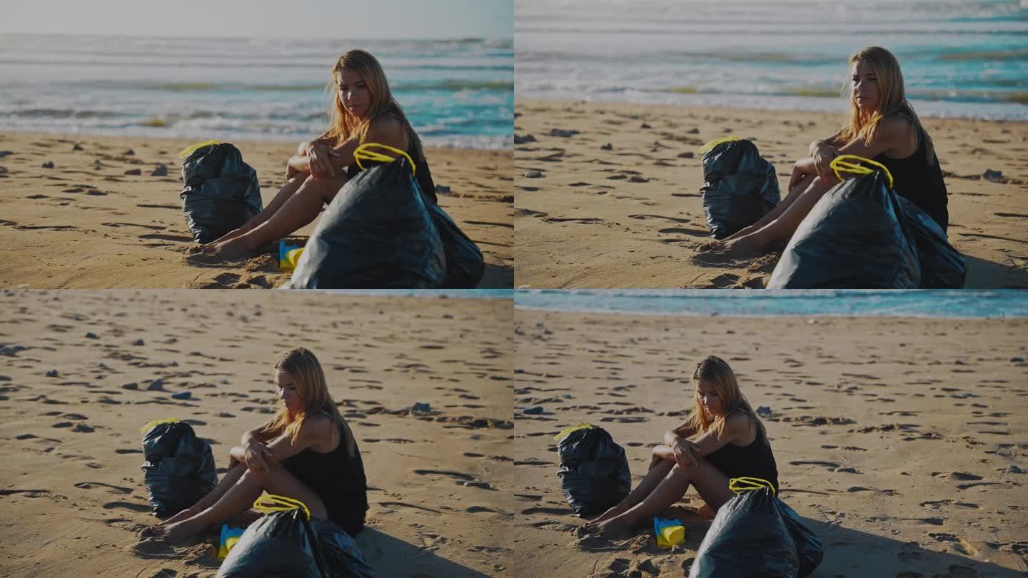 在清理了一整天的海滩塑料后，一名女子在阳光明媚的海滩上放松