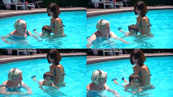 暑假，妈妈和奶奶带着孙子在游泳池里玩耍