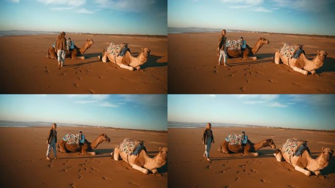在撒哈拉沙漠的沙滩上，女游客带着骆驼休息