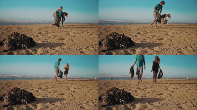 两个慈善工作者在海滩上捡垃圾