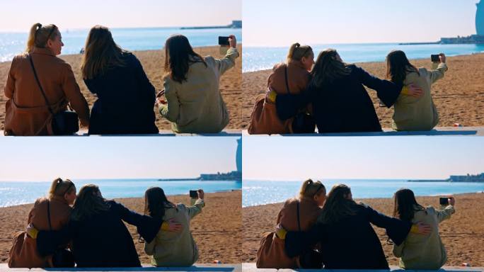 三个女性朋友在巴塞罗那海滩上自拍。只适合女孩的旅行。让记忆