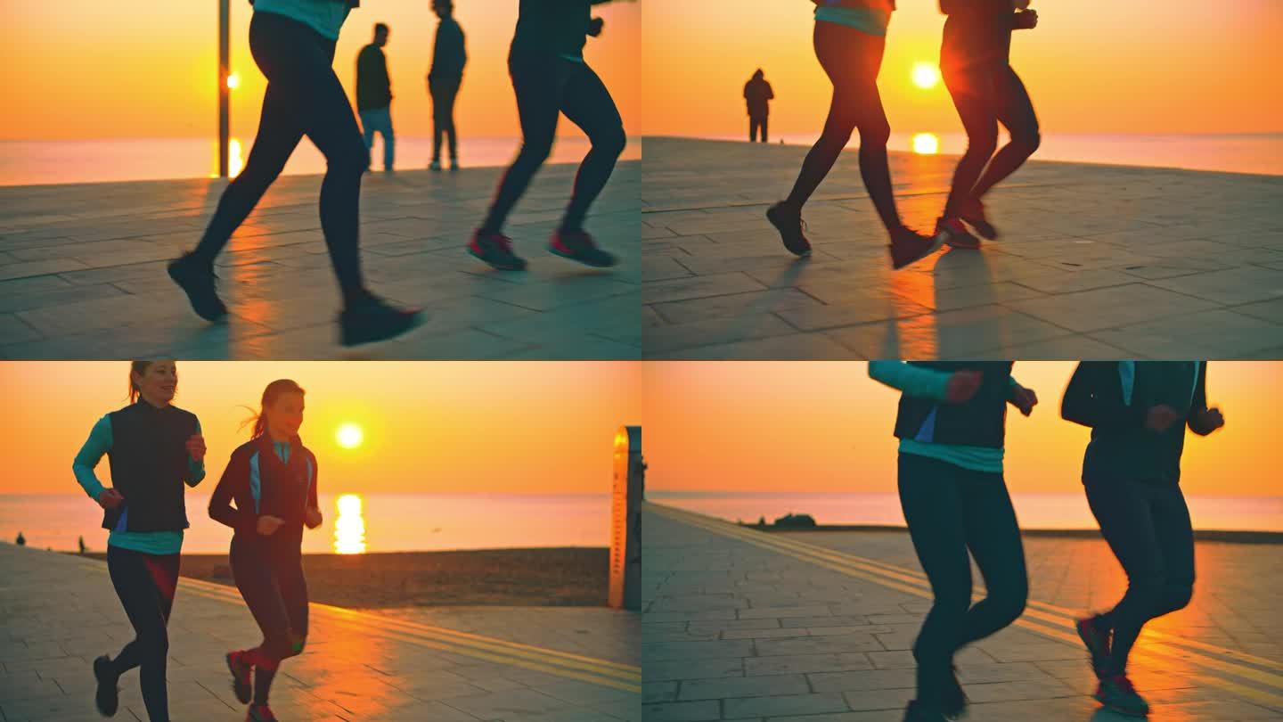日出时分，两名女子在巴塞罗那的海滩上慢跑。