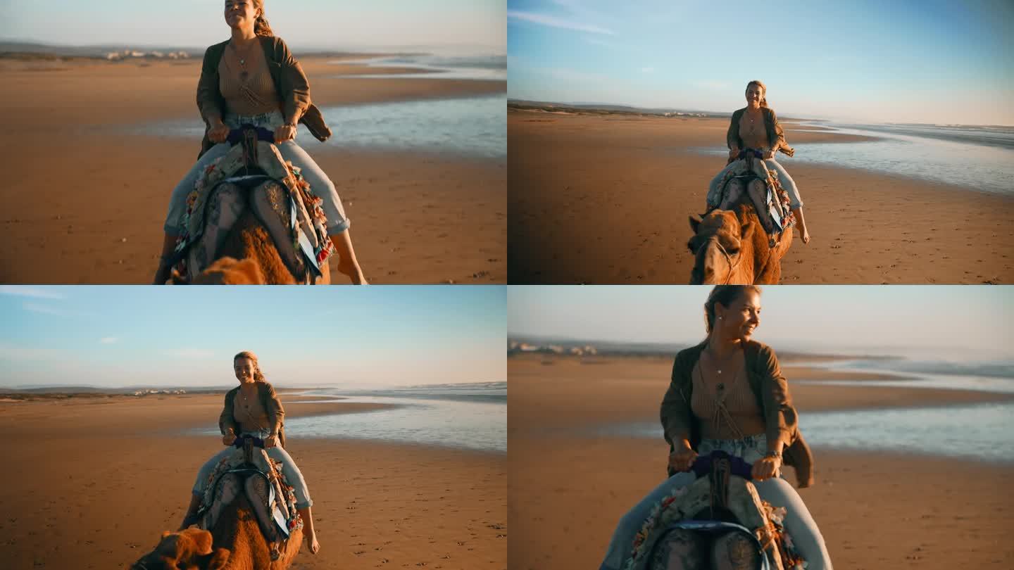 兴致勃勃的女游客沿着海岸线骑骆驼