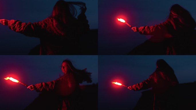 一个美丽的女孩在日落后拿着红色的照明弹在海滩上奔跑。摆脱沮丧的感觉。蓝色的小时。挥舞红火炬的女子