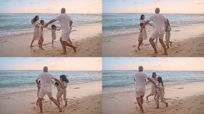 一个快乐的家庭，男人和女人手牵着手，带着孩子在海洋海滩的海水中玩耍。小孩子和爸爸妈妈在热带岛海岸跳舞