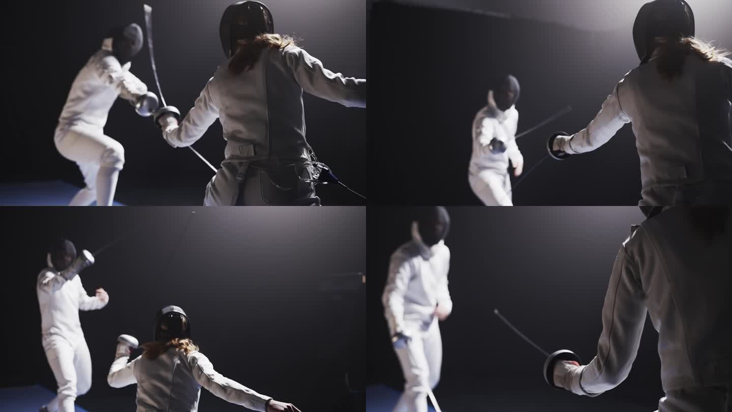 两名职业击剑运动员戴着防护装备在比赛中互掷花剑