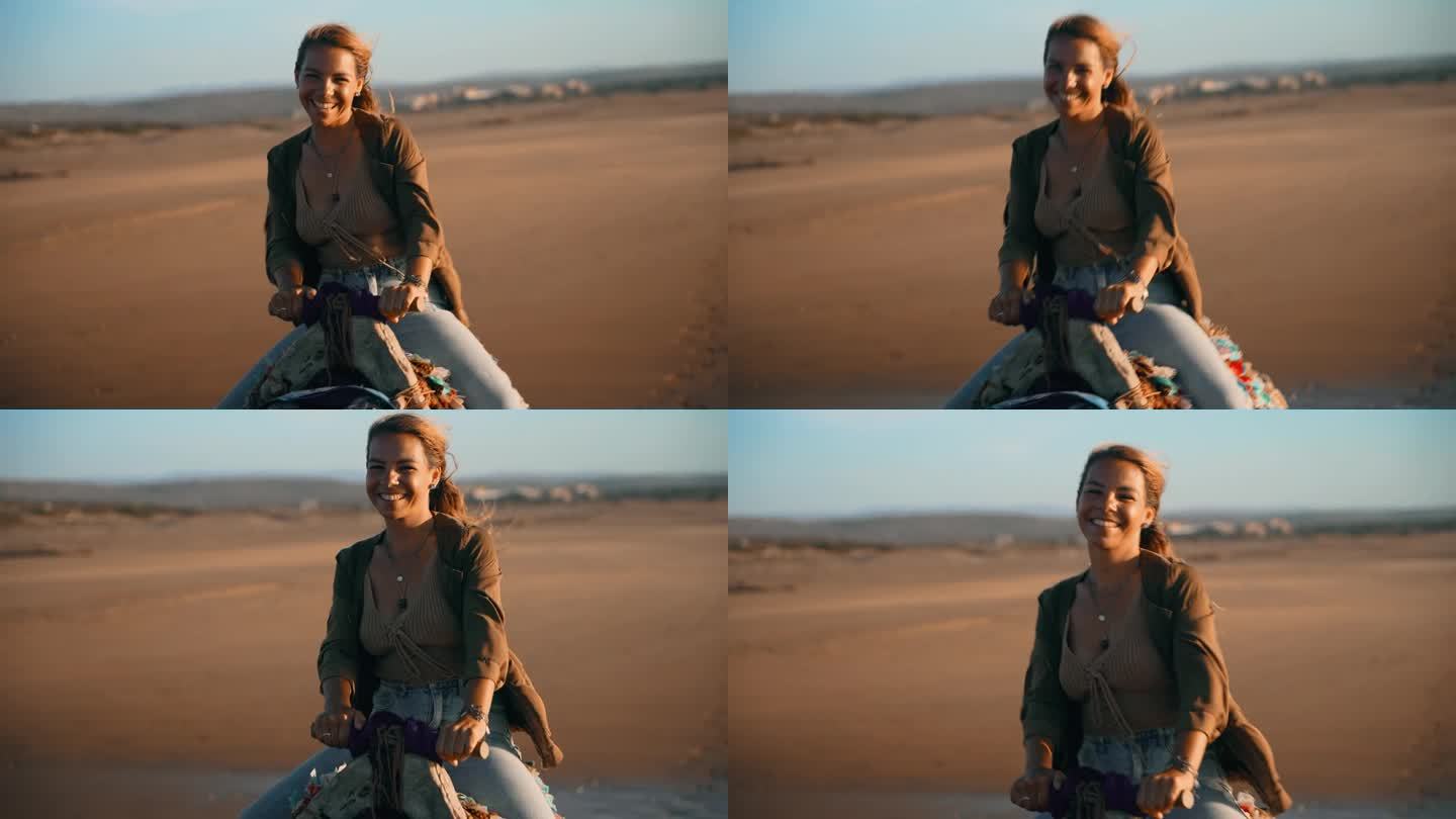 在沙滩上骑骆驼的女游客