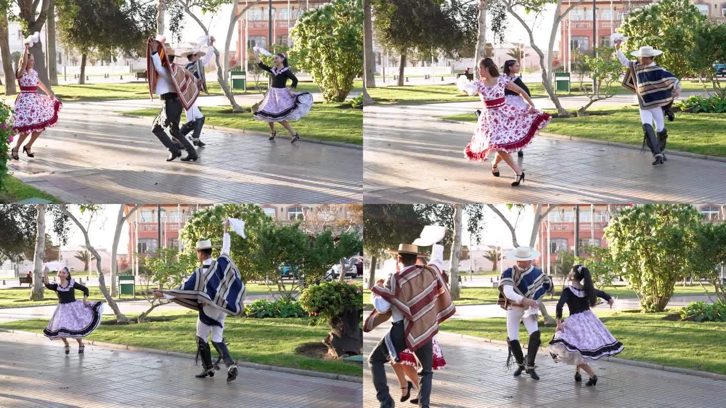 在镇广场上，四个人打扮成花絮跳舞的cueca