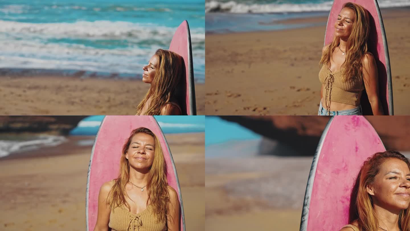 一名女子倚在沙滩上的粉色冲浪板上享受阳光，她对着镜头微笑