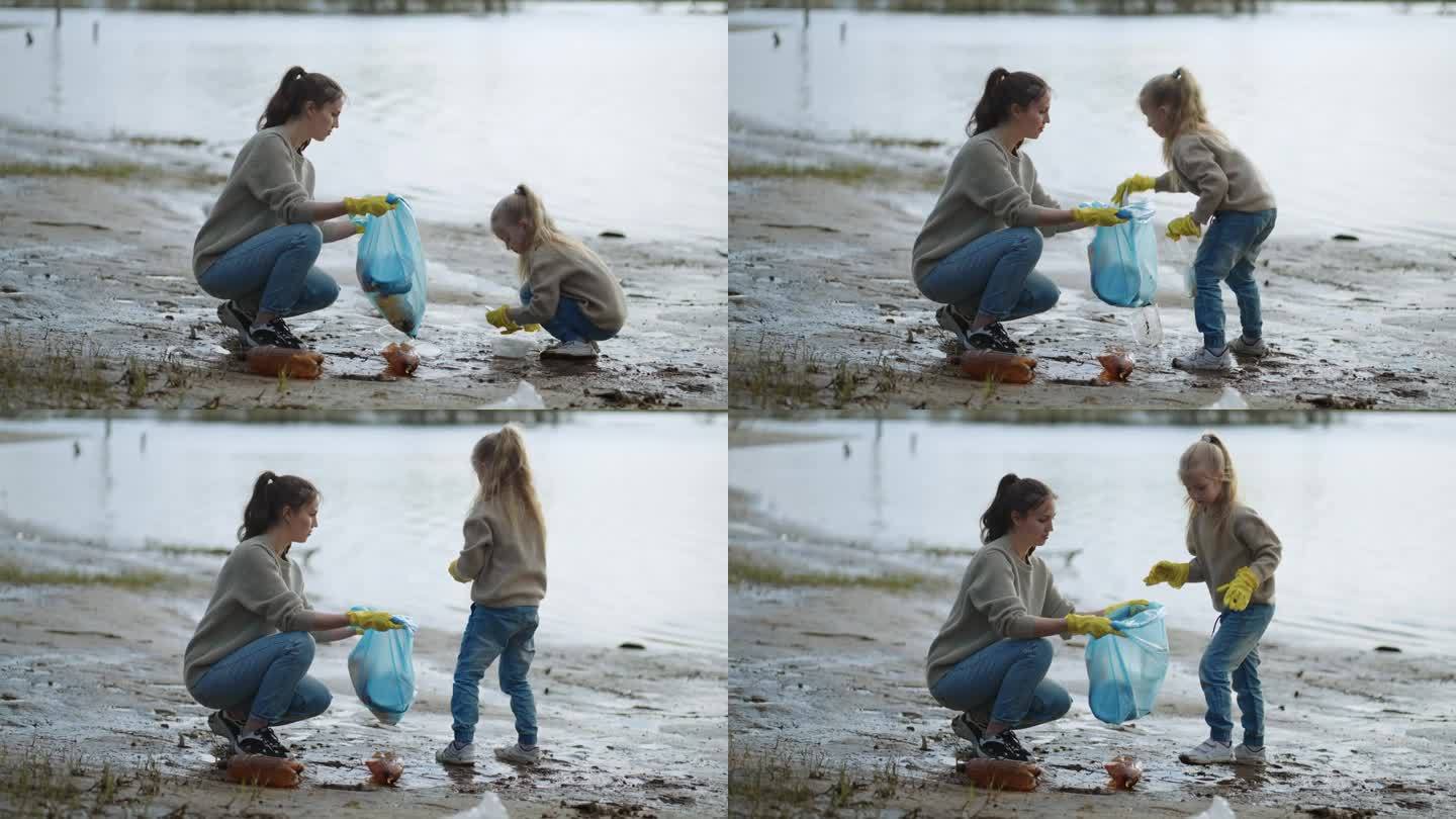 志愿者妇女和她的小女儿在湖边收集垃圾，生态和环境