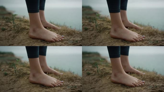 女孩站在山顶的腿特写。不知名的赤脚女子在海滩上放松
