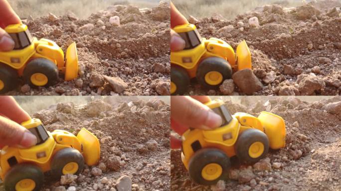 在地上玩玩具挖掘机