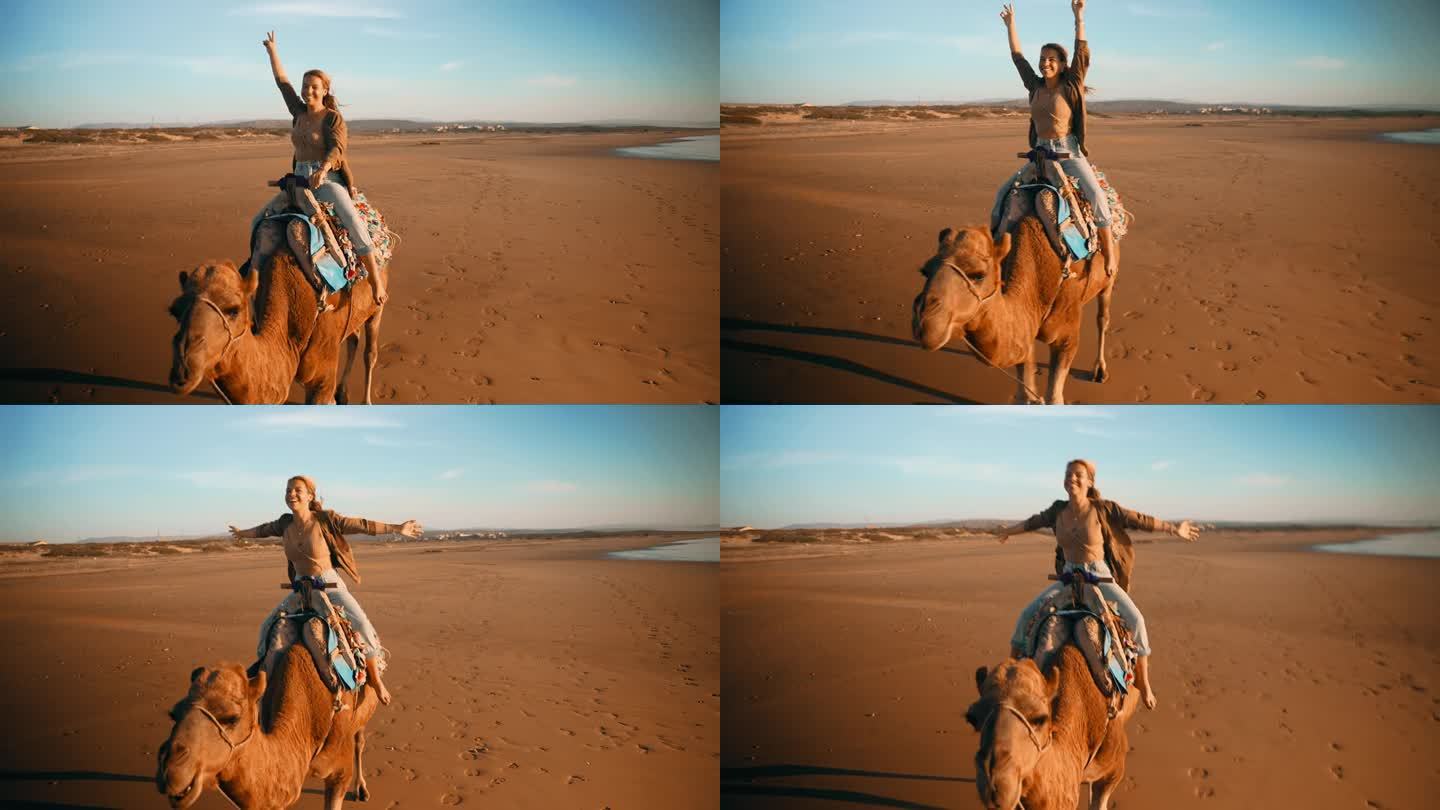 悠闲的女游客在海滩骑骆驼