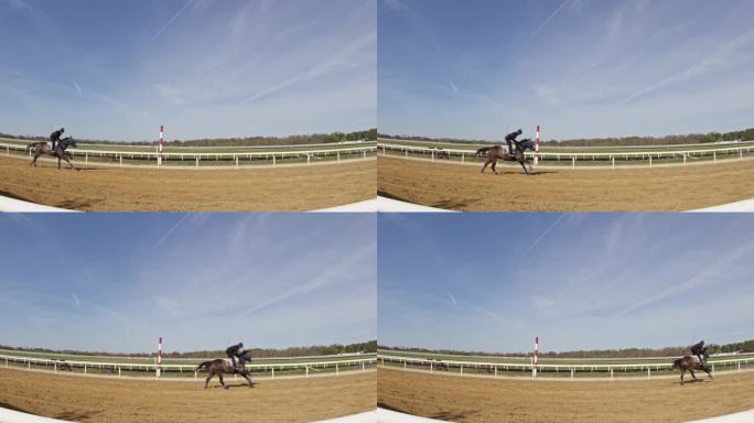 一名骑师在训练中吹拂一匹纯种马的超广角镜头