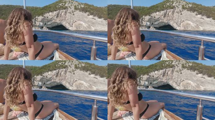 在希腊塞弗罗尼亚的梅加尼西，一名妇女正享受着向帕帕尼克利斯洞穴航行的船景
