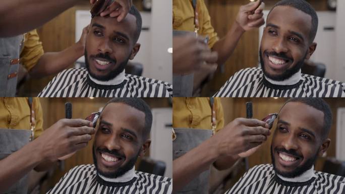 快乐的非洲裔美国人在理发店用剪子剪时髦的发型