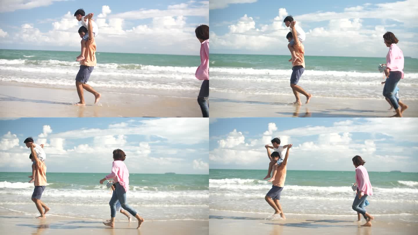 亚洲家庭带着快乐的情绪在海滩上奔跑