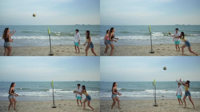一群朋友在沙滩上一起打排球。