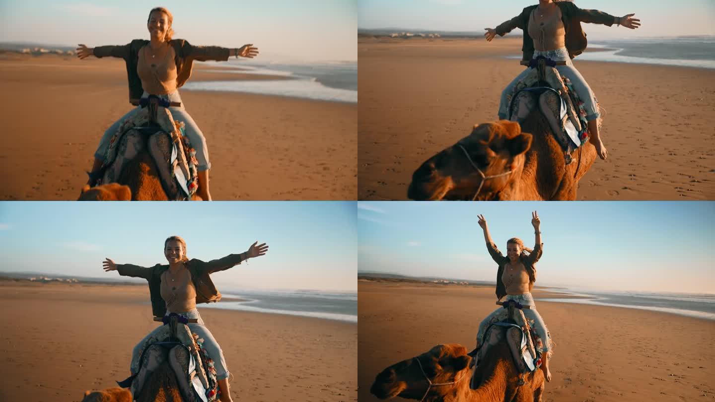 兴致勃勃的女游客在海滩上骑骆驼
