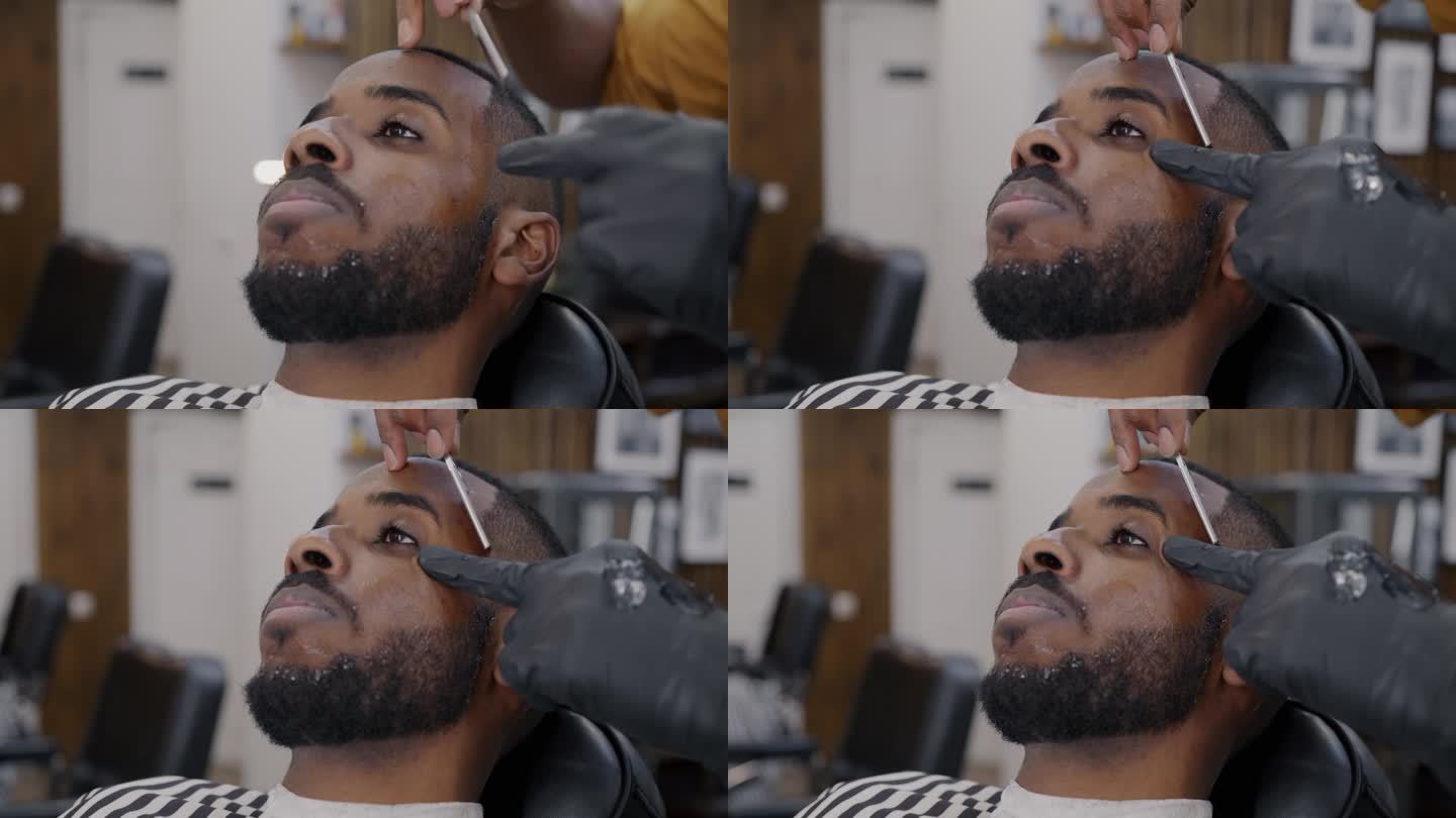 在现代沙龙里，放松的理发店顾客用剃刀享受剃须的特写肖像