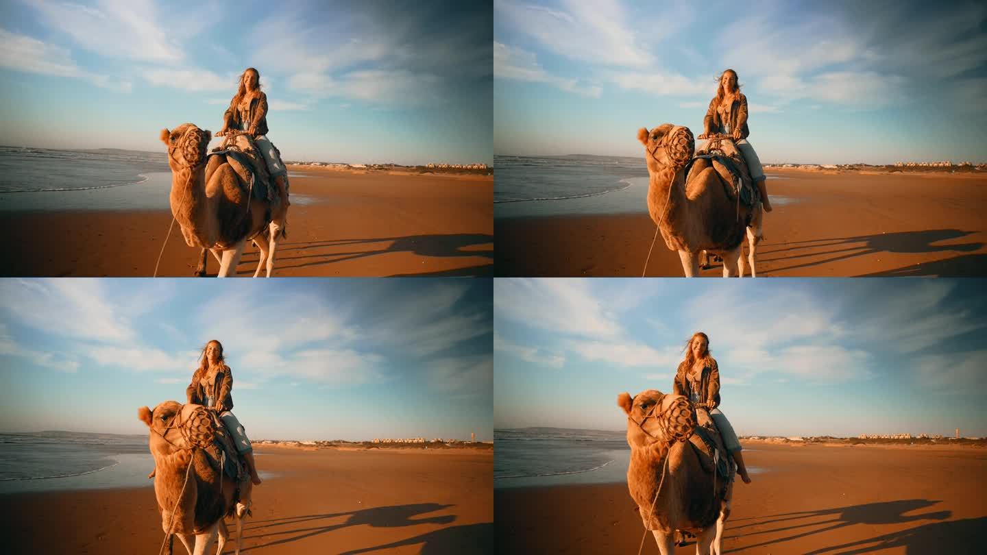 女游客在海滩骑骆驼玩得很开心