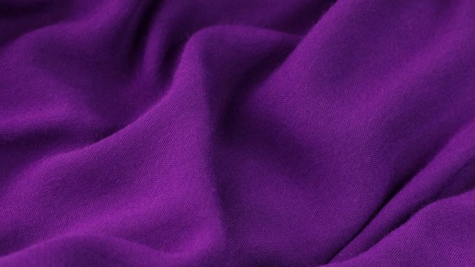 紫色织物背景。紫色布料波浪背景纹理。紫色织物布料纺织材料。