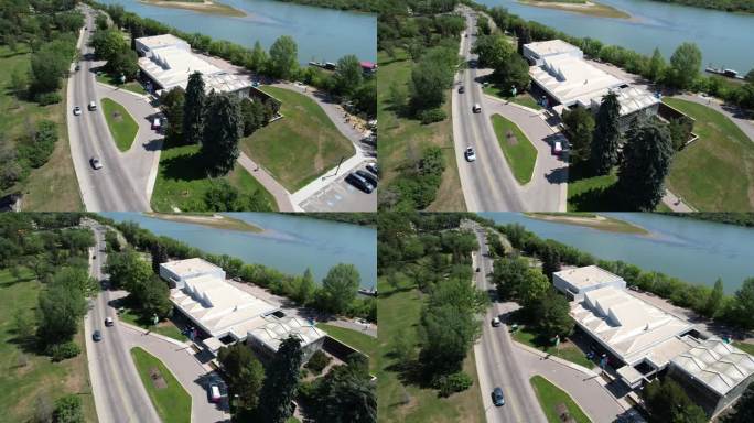 加拿大萨斯卡通郊区房屋和蓝天池塘边草坪的航拍画面