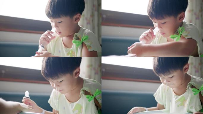 亚洲小男孩在医院做鼻腔冲洗清洁