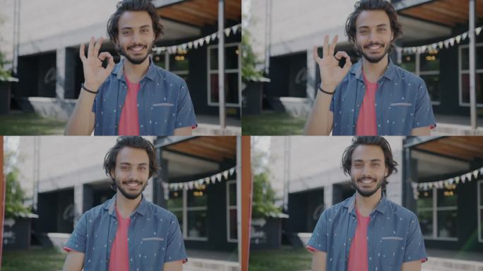 在夏天的城市里，快乐的中东人站在户外，展示着OK的手势和微笑