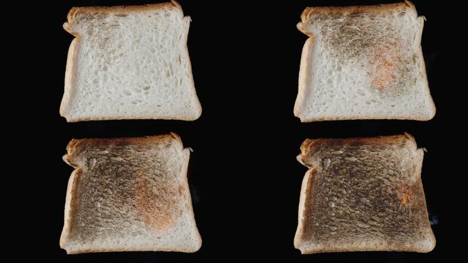 黑底白面包:黑底白面包片，上面覆盖着烧焦的面包皮，冒着热气。隔离