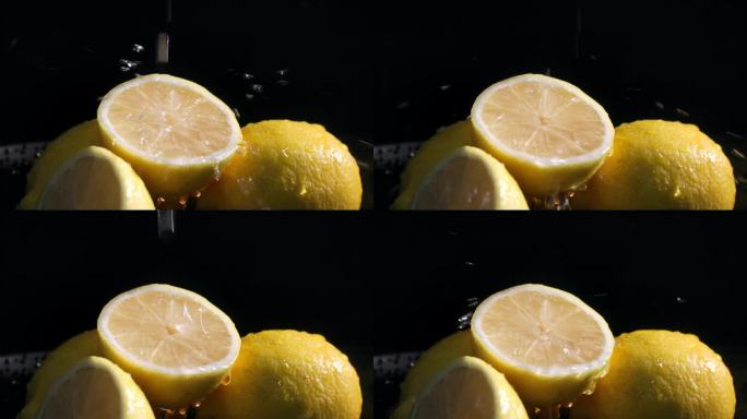 71个水果，成熟多汁的柠檬果肉加水倒在深色背景上，特写