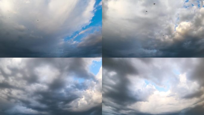 蓝色的夏日天空中飘着一大片灰色的云。阴雨的云景在大气中积聚。低角度视图。间隔拍摄。
