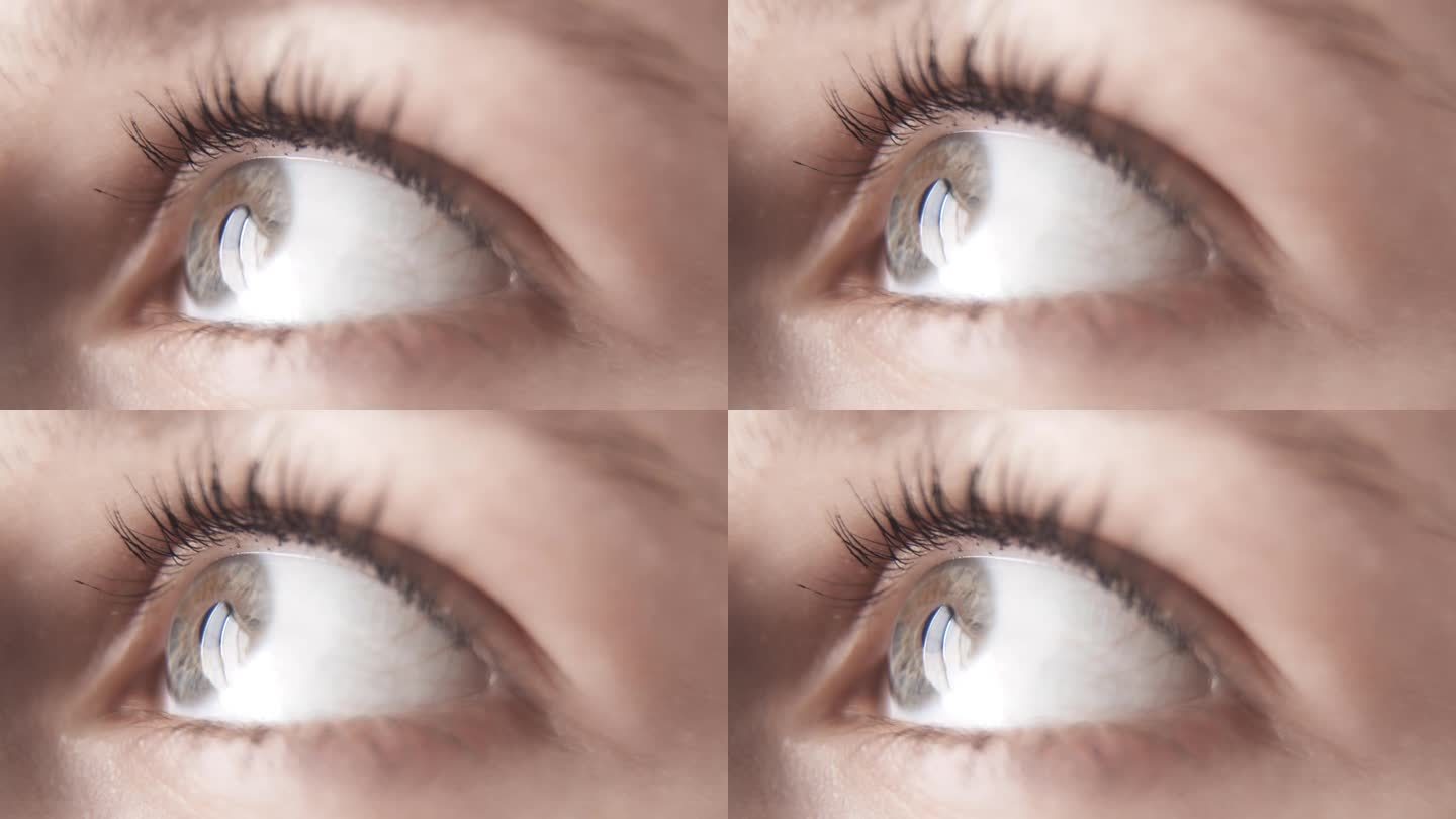 一个年轻女子抬头望着窗外的灰色左眼。健康的眼睛。良好的视力。眼科学