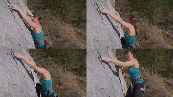 特写，DOF:运动攀岩者向上移动到快拔和夹攀岩绳