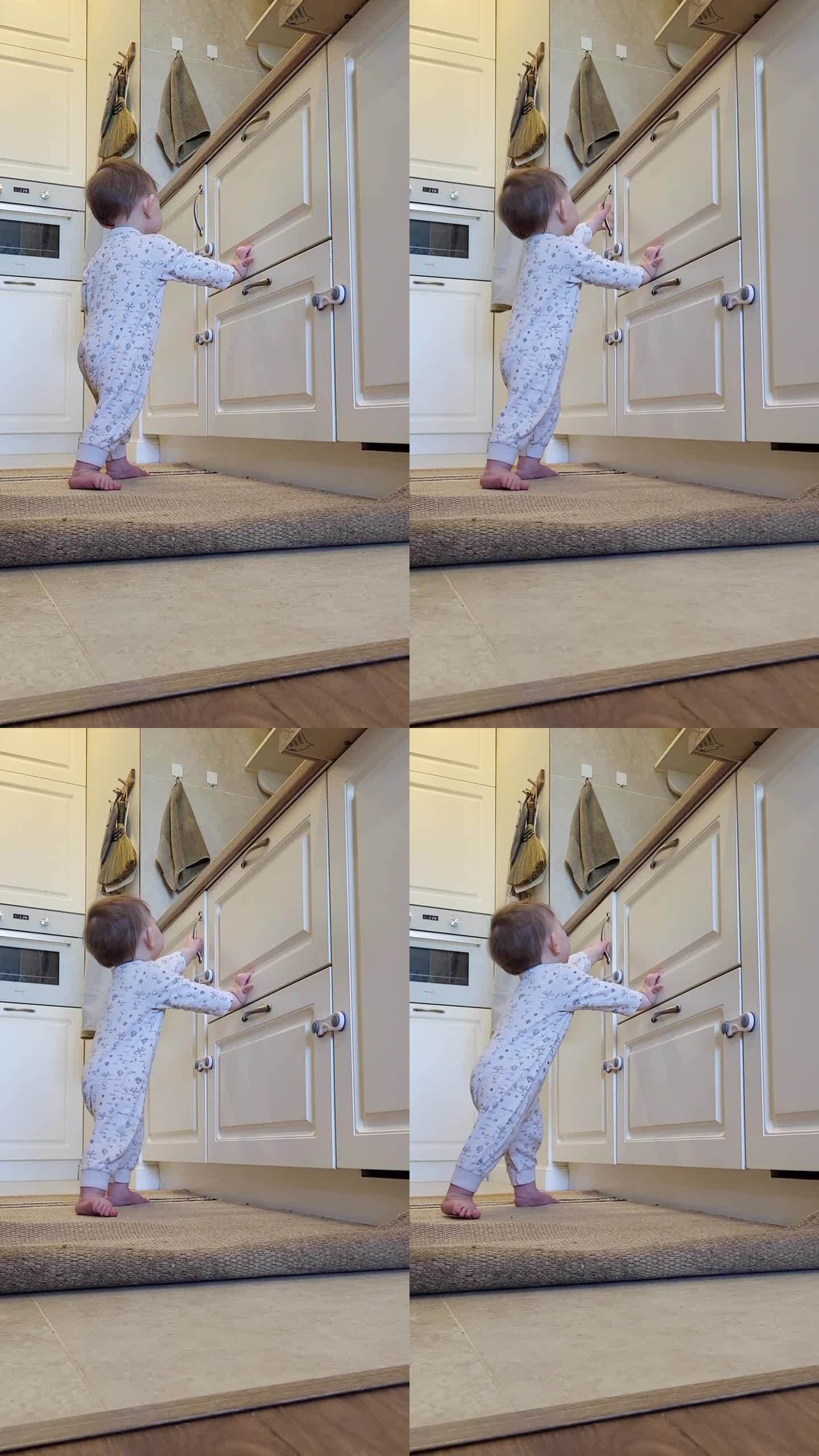 小婴儿打开了一个封闭的壁橱的门。一个好奇的孩子试图打开家具里的抽屉。10个月大的孩子