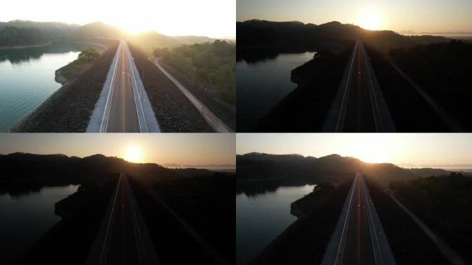 从空中拍摄的日出，对河上空旷的道路进行多重曝光
