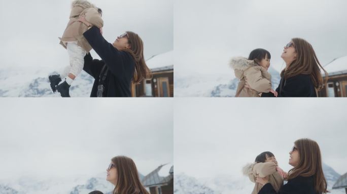 快乐的亚洲妈妈抱着可爱的女孩
在度假的时候一起在雪山玩耍。