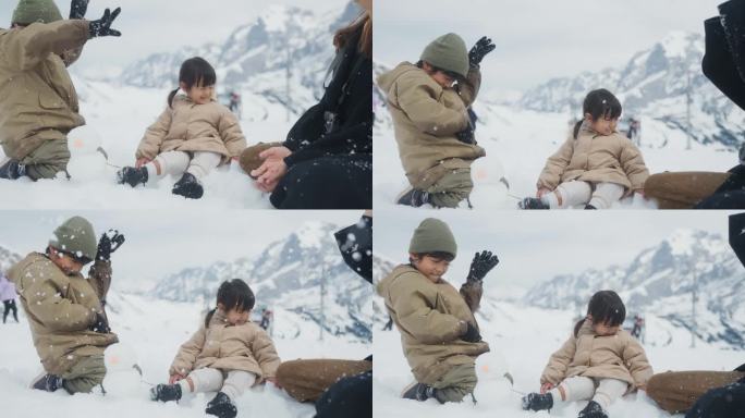 亚洲妈妈和她的孩子在雪中玩耍，一起把雪扔到空中。