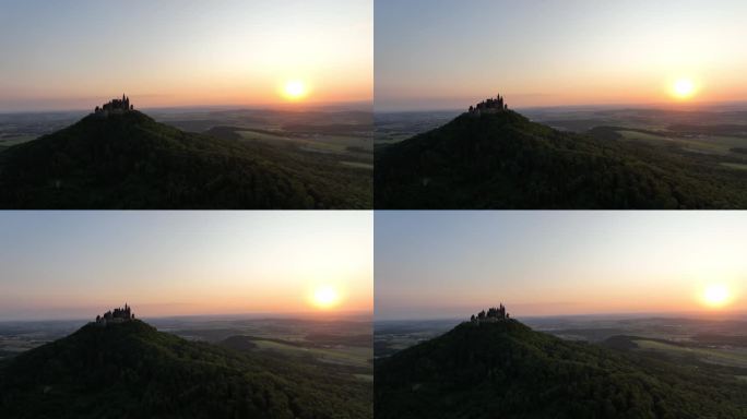 日落时分，无人机在一座古堡前飞行，古堡位于一座山上