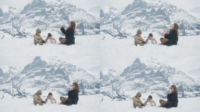 美丽的妈妈在雪地里和小男孩小女孩玩，还把雪抛向空中。
