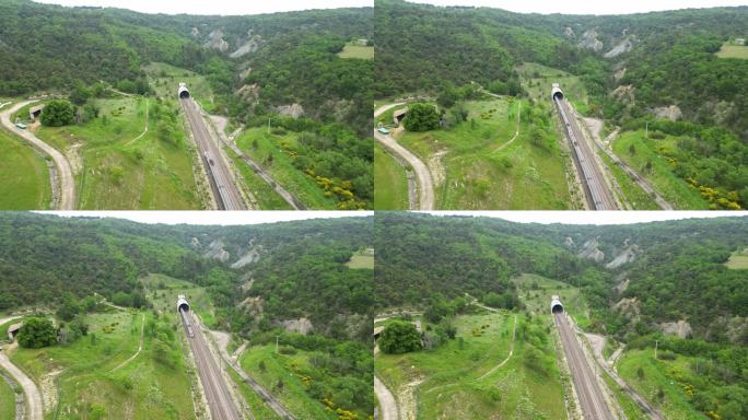 一列高速客运列车进入山脚下隧道的无人机全景图。俯瞰法国南部的群山