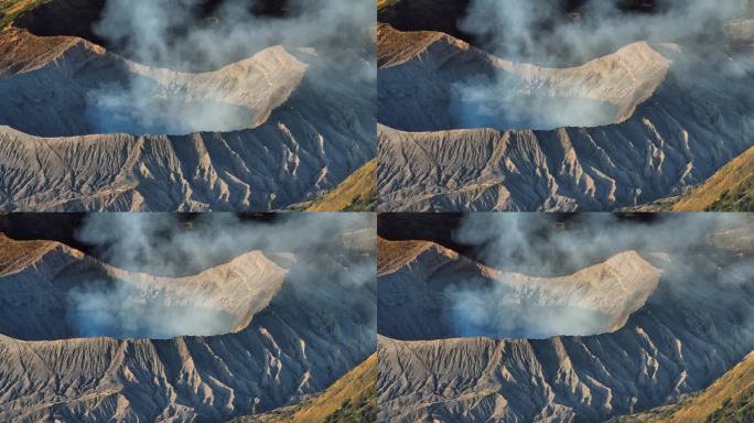 航拍无人机拍摄的日出场景，火山喷发的烟雾被云雾包围。Bromo, sememeru, Batok和W