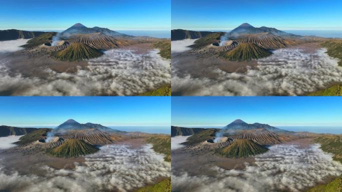 空中无人机拍摄的印尼爪哇岛东爪哇岛腾格里火山口喷发火山Bromo火山的日出场景，周围有云、雾和烟，还