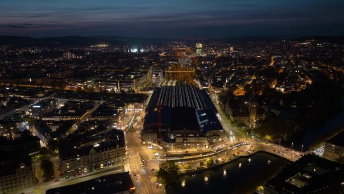 日落天空夜间照明飞行在苏黎世市中心主要火车站空中全景4k延时瑞士
