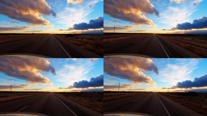 汽车驶入沙漠日落:新墨西哥州