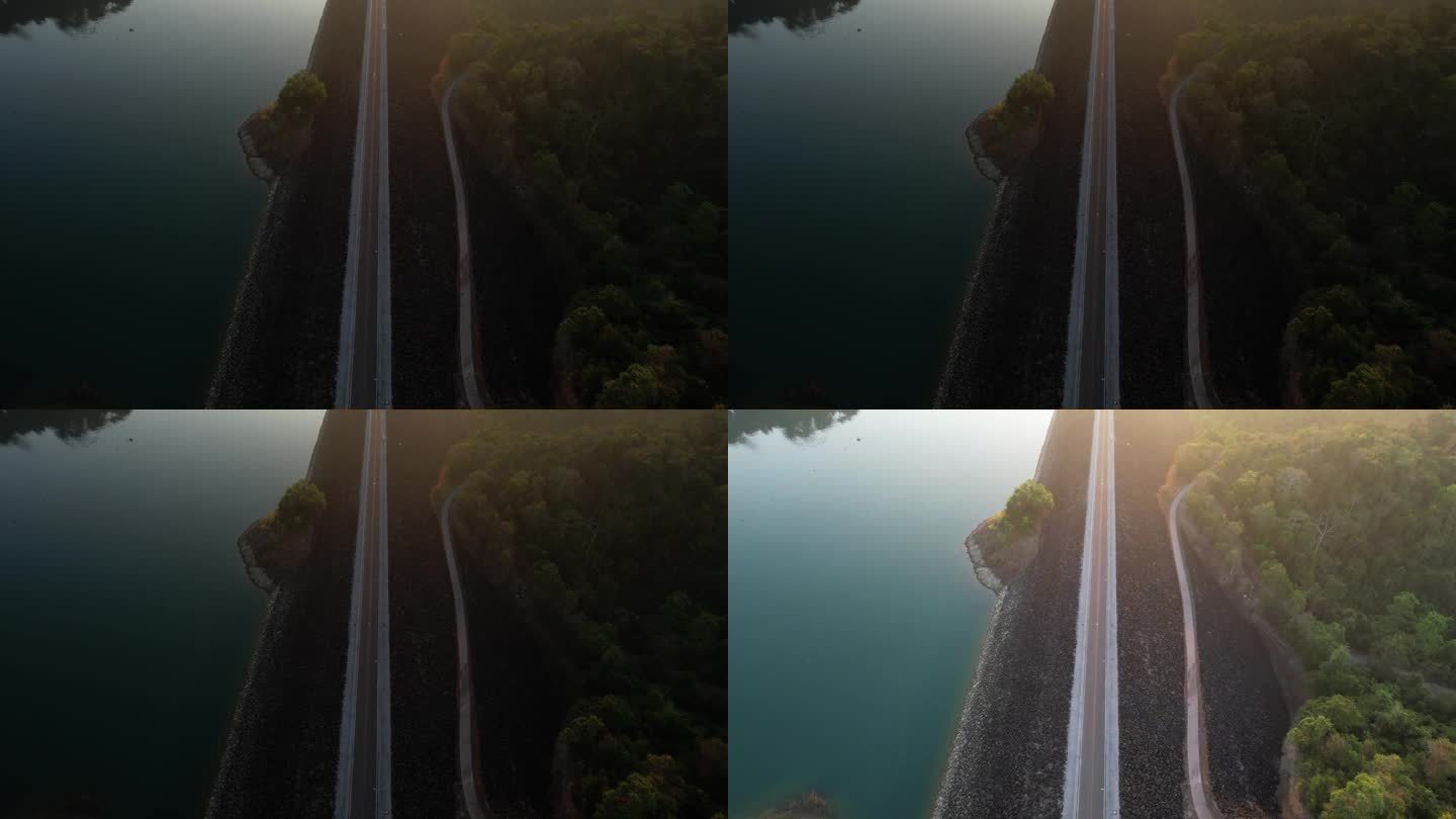 从空中拍摄的日出，对河上空旷的道路进行多重曝光