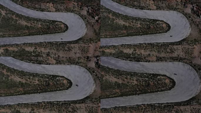 无人机4k剪辑与公路骑车人在风景秀丽的蜿蜒道路上，希腊凯法利尼亚岛