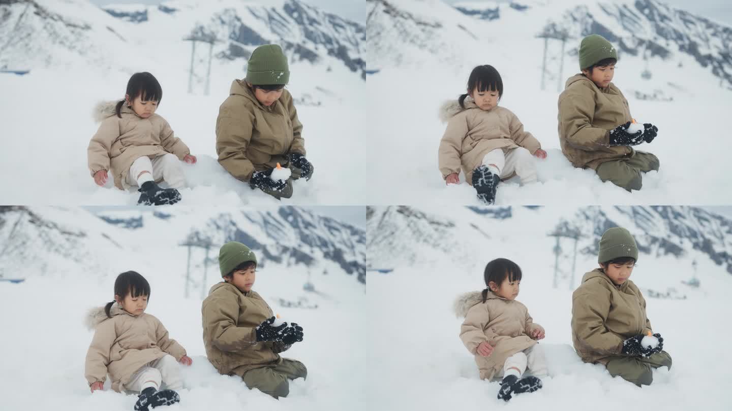 男孩和女孩一起坐在雪山上，哥哥给妹妹堆了一个可爱的雪人。
