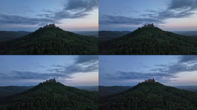 日落时分，无人机在一座古堡前飞行，古堡位于一座山上